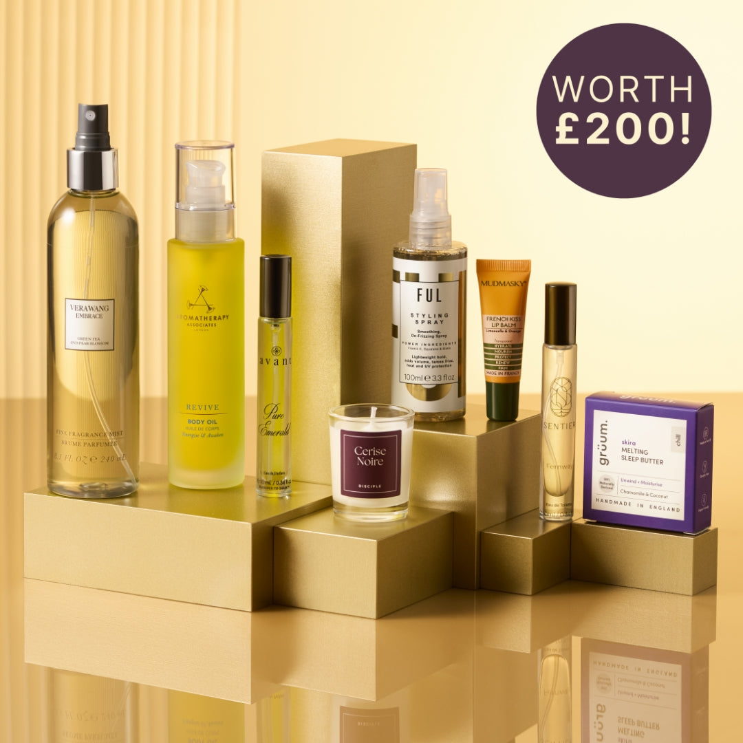 Collection of beauty products on a reflective surface with a 'Worth £200!' label.